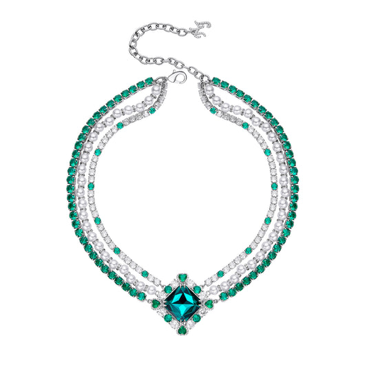 Crystal-embellished diamond shape necklace with green emerald accents.